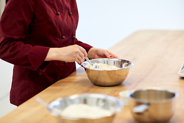 Image showing chef with flour in bowl making batter or dough