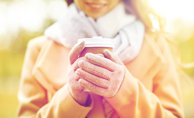 Image showing close up of happy woman with coffee in autumn park