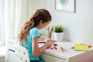 Image showing happy girl making something at home