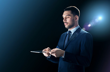 Image showing businessman in suit with transparent tablet pc