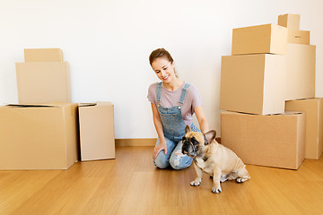 Image showing happy woman with dog and boxes moving to new home