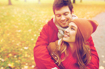 Image showing happy young couple hugging in autumn park