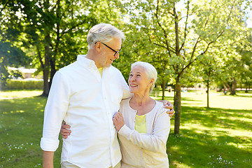 Image showing happy senior couple hugging in city park