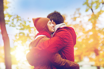 Image showing happy young couple hugging in autumn park