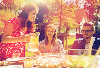 Image showing happy friends having dinner at summer garden party