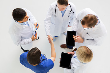 Image showing doctors with tablet pc doing handshake at hospital