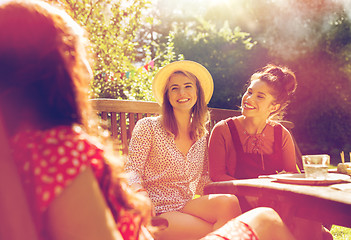 Image showing happy friends having dinner at summer garden