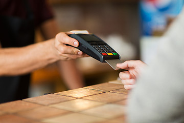 Image showing hands with payment terminal and credit card