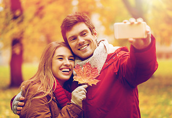 Image showing couple taking selfie by smartphone in autumn park