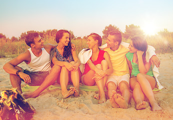 Image showing smiling friends in sunglasses on summer beach