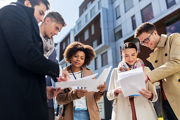 Image showing international business team with papers in city