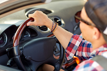 Image showing close up of happy man driving car