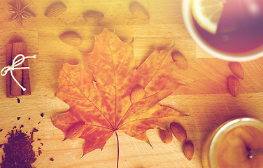 Image showing cup of lemon tea and honey on wooden board