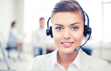 Image showing helpline operator with headphones in call centre