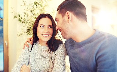 Image showing happy couple hugging at cafe or restaurant