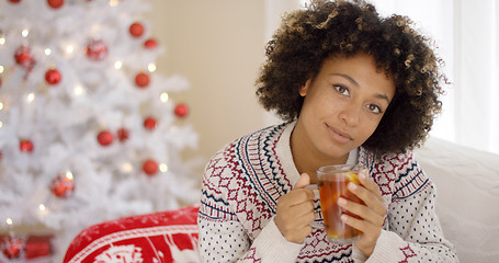 Image showing Thoughtful young woman drinking a mug of tea