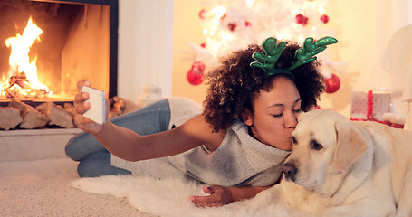 Image showing Cute young woman taking a selfie with her dog