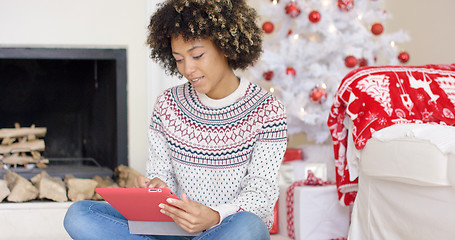 Image showing Young woman surfing the internet at Christmas