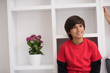 Image showing young boy posing on a shelf