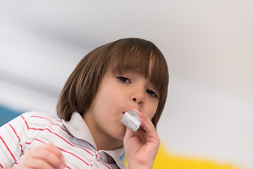 Image showing kid blowing a noisemaker