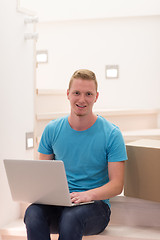 Image showing young man sitting in stairway at home