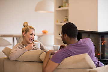 Image showing Young multiethnic couple  in front of fireplace