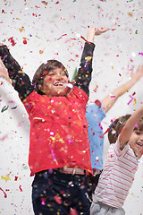 Image showing kids  blowing confetti