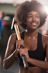 Image showing black woman after workout with hammer