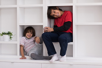 Image showing young boys posing on a shelf