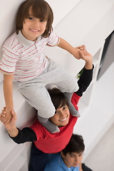 Image showing young boys posing line up piggyback top view