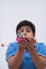 Image showing kid blowing confetti