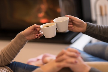 Image showing Young couple  in front of fireplace