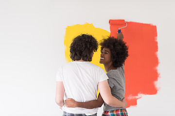 Image showing multiethnic couple painting interior wall