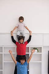 Image showing young boys posing line up piggyback