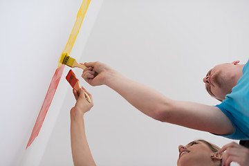 Image showing couple painting interior wall