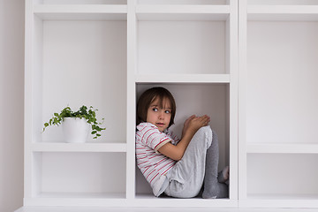 Image showing young boy posing on a shelf