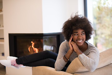 Image showing black woman in front of fireplace