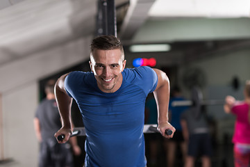 Image showing man doing exercises parallel bars