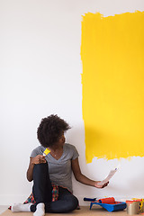 Image showing back female painter sitting on floor