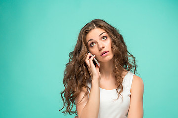 Image showing The portrait of disgusted woman with mobile phone