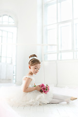 Image showing The little balerina in white tutu in class at the ballet school