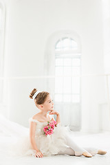 Image showing The little balerina in white tutu in class at the ballet school