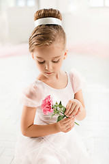 Image showing The little balerina in white tutu in class at the ballet school