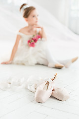 Image showing The little balerina in white tutu in class at the ballet school