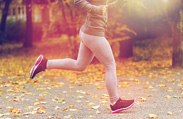 Image showing close up of young woman running in autumn park