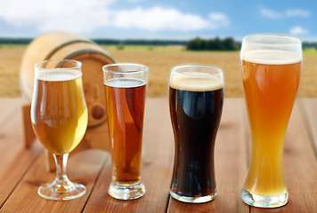 Image showing different types of beer in glasses on table