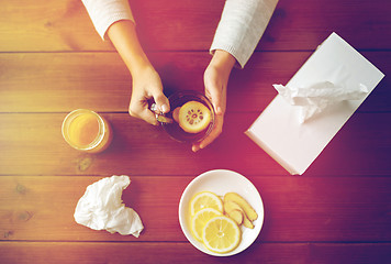 Image showing ill woman drinking tea with lemon and ginger