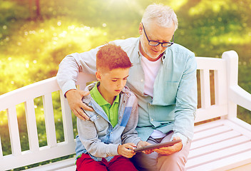 Image showing grandfather and boy with tablet pc at summer park