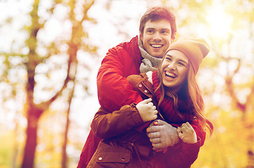 Image showing happy young couple hugging in autumn park