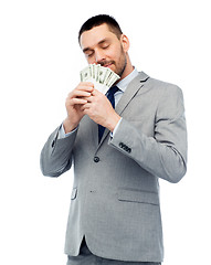 Image showing businessman smelling american dollar money